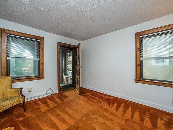 The living area is light with two wood trimmed windows.