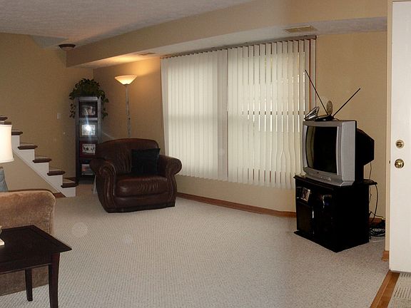 Comfortable living room is enhanced by beautiful new carpet & fresh paint.