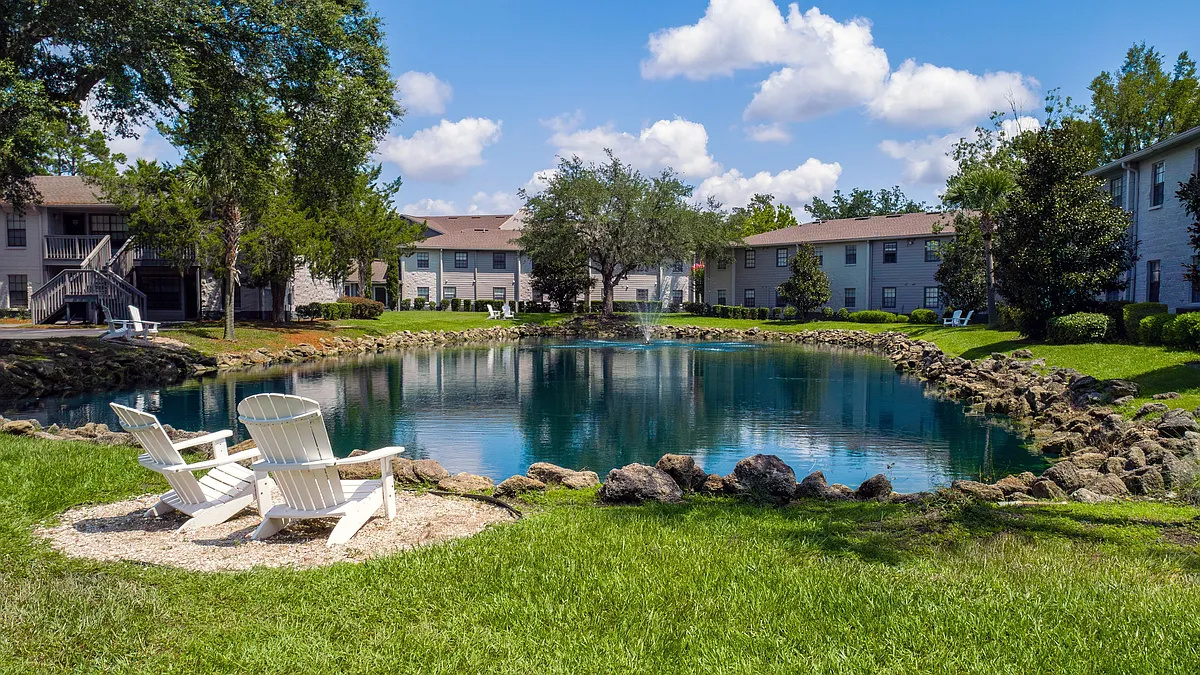 Relish serene seating areas by the pond. - Ridgemar Commons