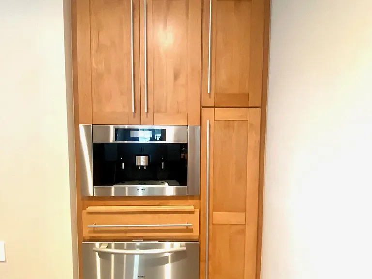 Built in coffee machine and warming drawer. Pantry and more storage.