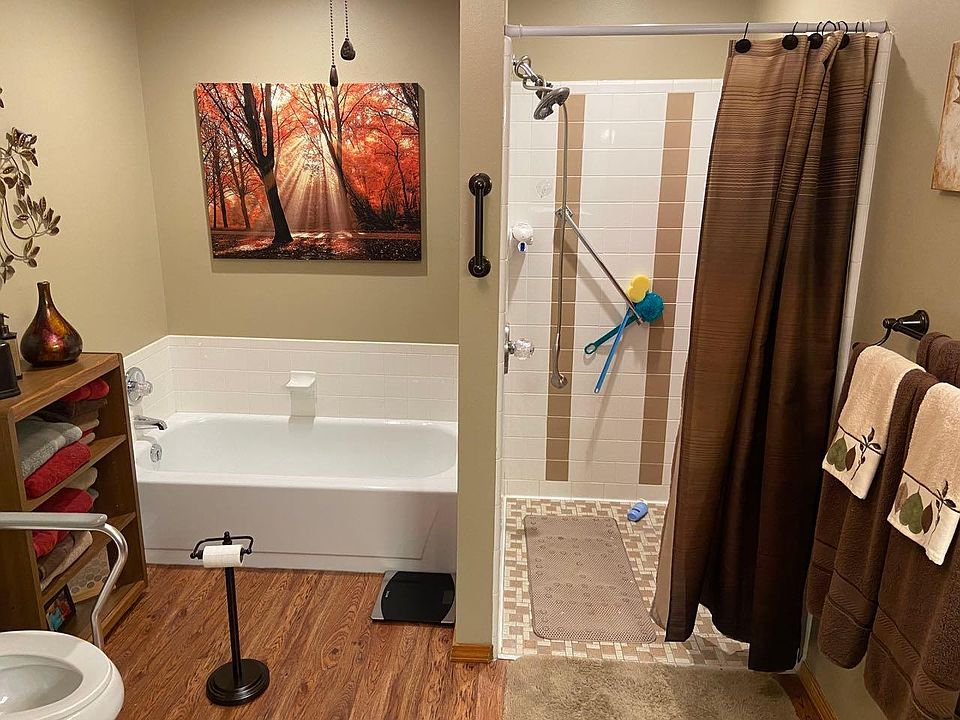 Bath showing handicap accessible shower with separate tub.