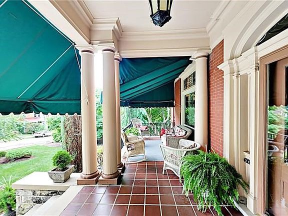 Relax on the front porch with tile floor and shade awnings