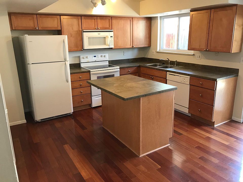 Kitchen with cherry hardwood floors and porcelain countertop