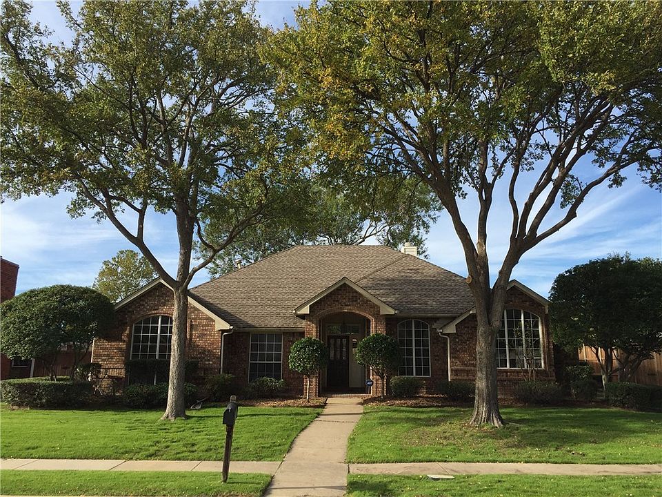 Professionally trimmed trees and established landscape.