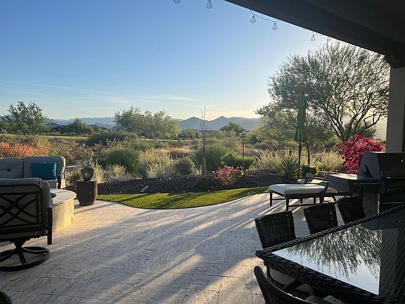 Panoramic mountain and golf course view from covered patio and inside the home
