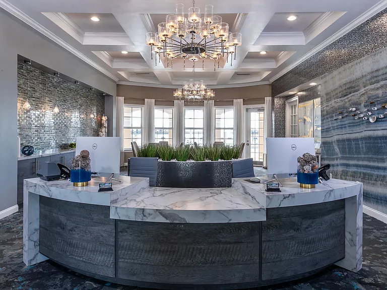 Step into sophistication with our beautifully designed leasing office featuring modern decor and elegant lighting.