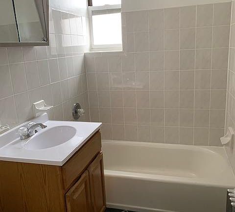 Good sized bathroom with ceramic tiles.