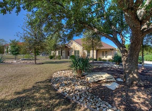 Exterior front of home showing nicely landscaped xeriscaped yard.