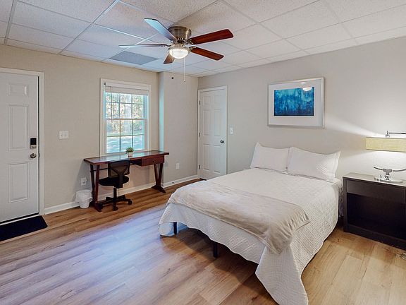 Bedroom complete with Private Access, full size bed, nightstand, desk, ceiling fan and closet.