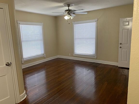 Living room: lots of natural light, crown molding on windows, newly refinished real hardwood floors