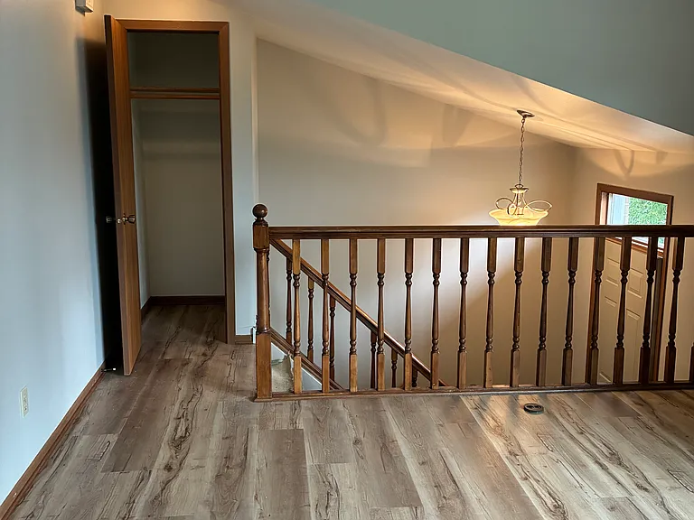 Stairs into great room with closet
