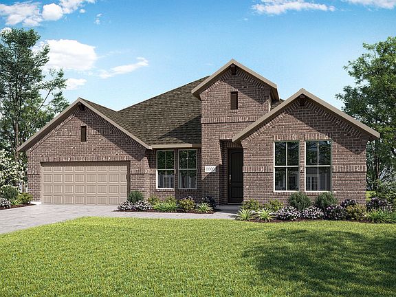 A two-story brick house with a gabled roof and a well-manicured lawn surrounded by lush greenery and