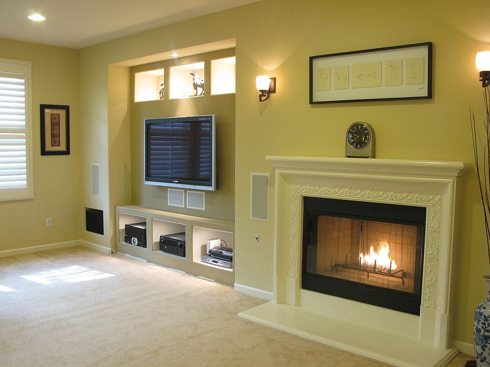 Open living room floor plan to adjoining chef's kitchen. Built-in entertainment center with in-wall/in-ceiling surround sound speakers. Gas fireplace.