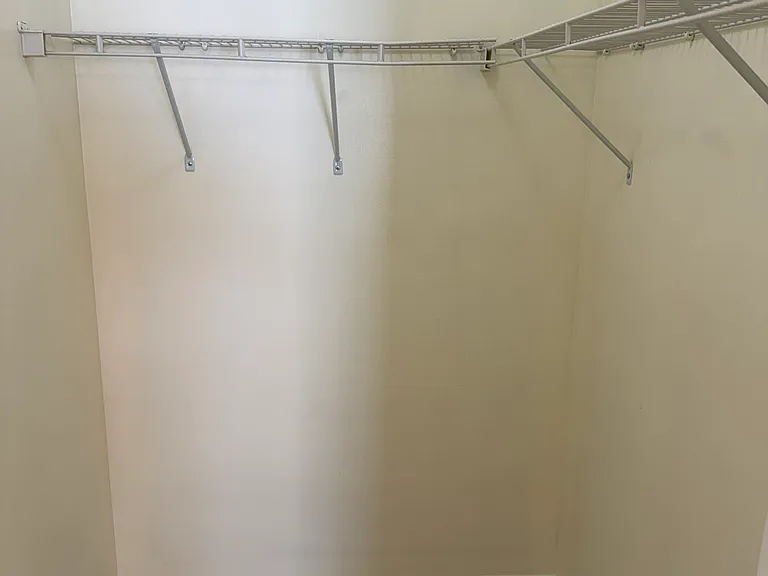 The spacious two walk-in closets have nice shelving.