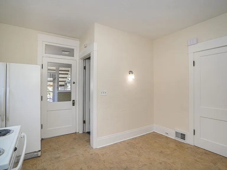 Kitchen with Pantry, Access to back Sun Porch & Staircase to Large Basement