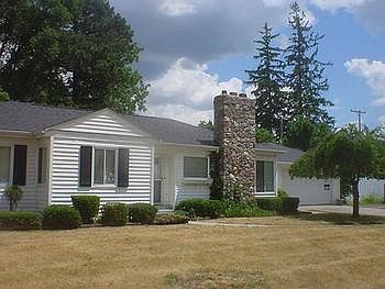 Stone fireplace on the outside and brick in the living room.