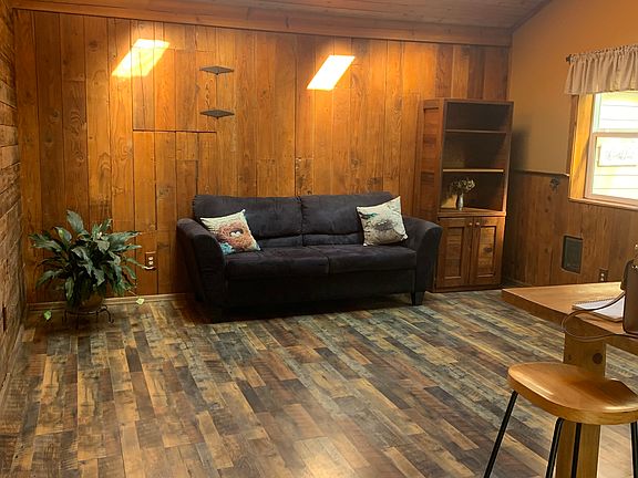 Living room with reclaimed wood walls and extra storage.