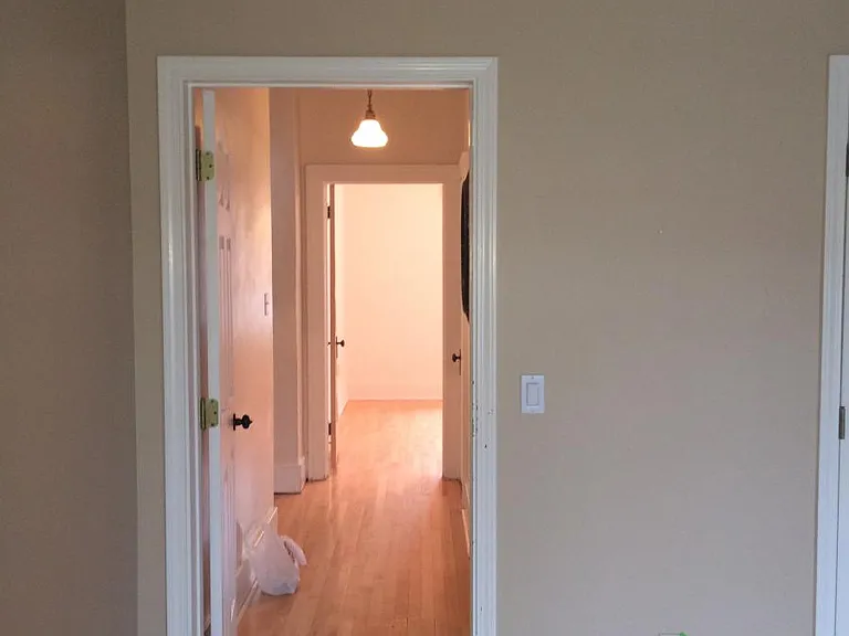 hallway to bedroom downstairs and full bathroom downstairs