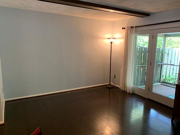 main floor living room with access to screened in porch and patio
