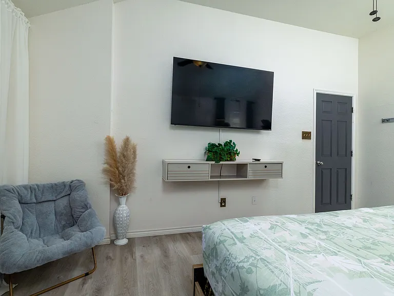 Cozy bedroom with a king bed and nature-inspired decor.