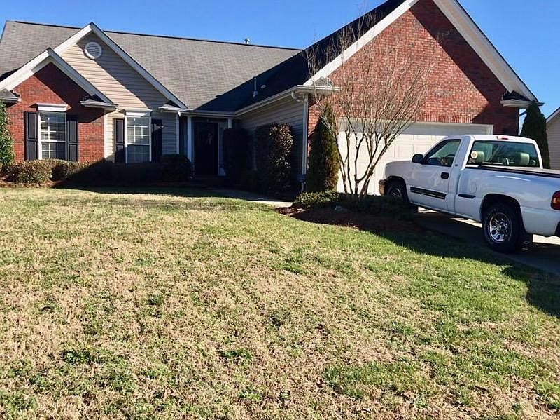 Front of house. Brick and Vinyl. 2 car garage with double driverway.