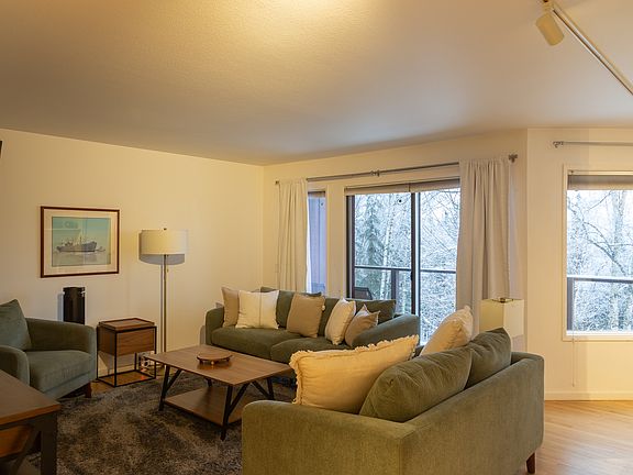Light, bright, comfortable living room with 60" smart TV