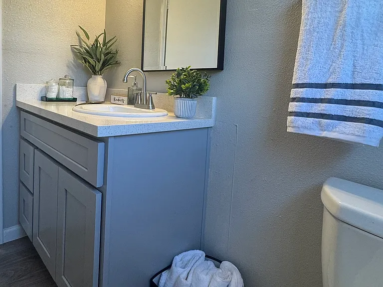 This stylish bathroom offers a contemporary vanity with updated lighting and a clean, functional layout.
