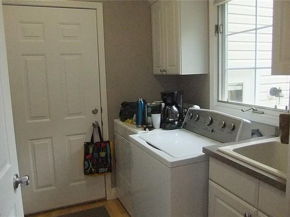 1st floor laundry room with double stacked cabinetry