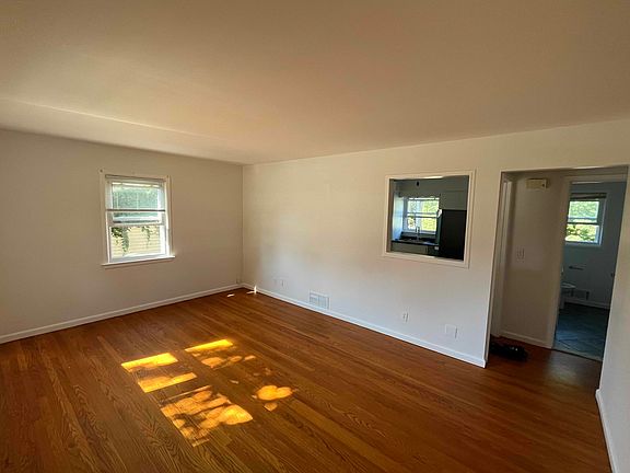 Living room includes three new blinds and view into kitchen.