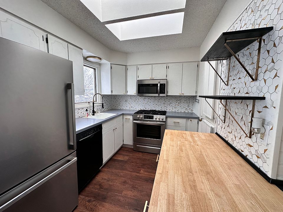 Kitchen showing new gas range, microwave, and fridge
