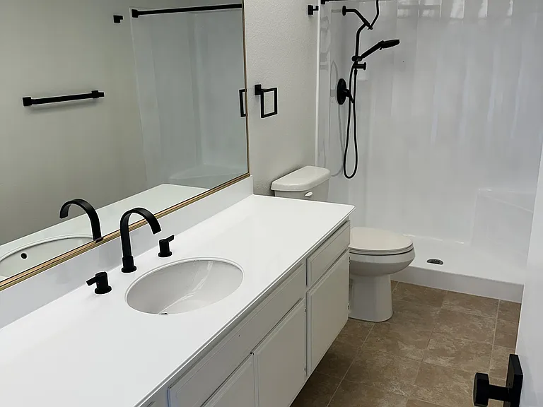 Primary Bedroom His & Hers Bathroom 1 of 2