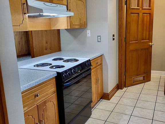 All equipped kitchen with full-size refrigerator with ice maker, stove, oven, dishwasher, double sinks, tile flooring and full-size washer and dryer with custom woodwork.