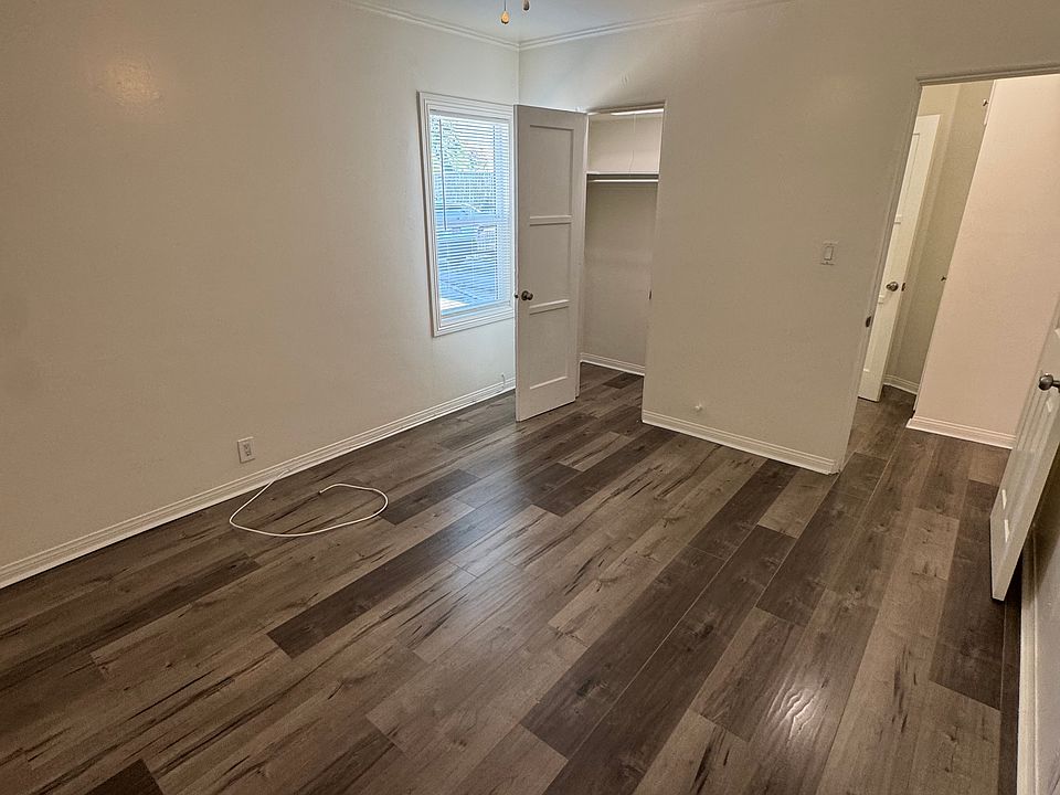 Bedroom from the bedroom corner viewpoint. Includes a newly replaced window, ceiling fan and closet