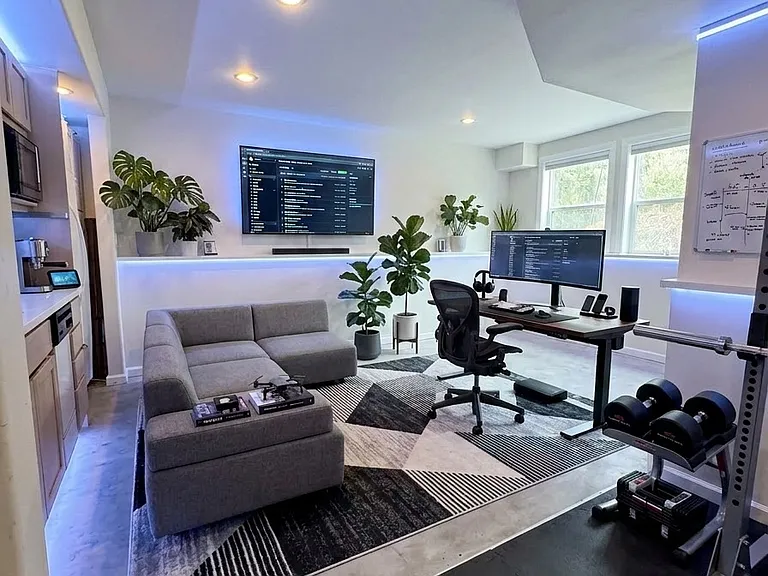 Garden level second master suite with private entry, kitchenette and full bathroom, styled with ai as a home office and gym.