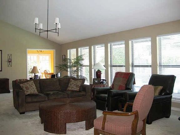 Spacious 33x17 family room with wall of windows that look out on pool