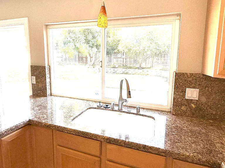 Large picture window facing beautifully manicured backyard.