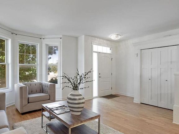 Unit entry into living room, large coat closet