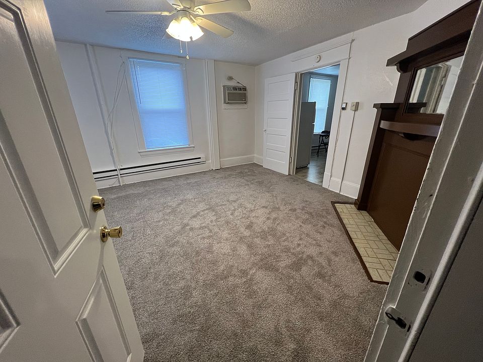 Family room with mirrored fireplace mantel. No fireplace