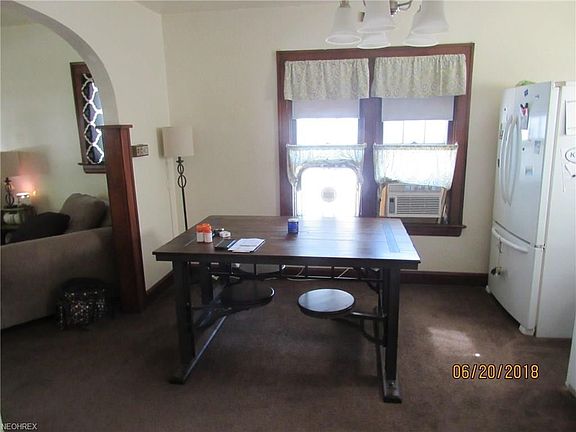 The dining room is off the kitchen and open to the living room. How about that character....arched doorway with beautiful, UNPAINTED hardwood moulding and trim.