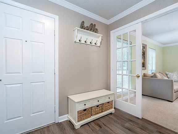 Upon entering this charming home, you step into an open foyer with gorgeous luxury vinyl plank flooring that flows throughout most of the main floor! Throughout the entire home, you'll find crisp white trim and doors that have been recently painted i