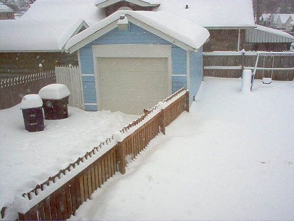 Garage viewed from back of house after winter storm