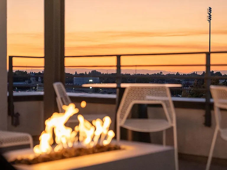 Experience relaxation on this rooftop patio, perfect for enjoying breathtaking sunsets.