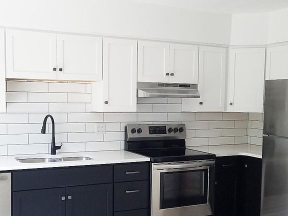 Kitchen with White Quartz Counter tops and Stainless Steel Appliances