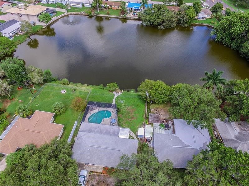 254 NW Lincoln Cir N - pool and pond view home