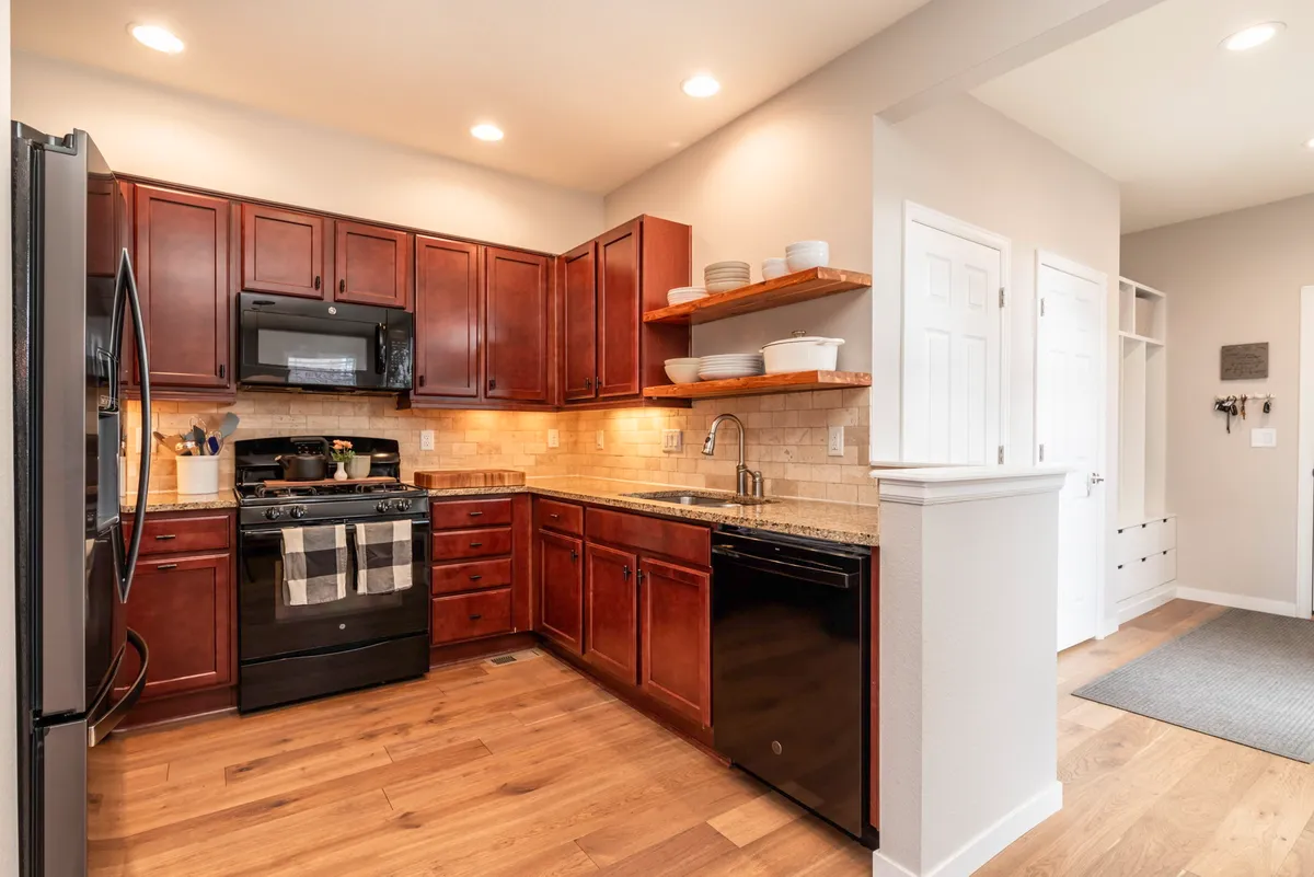 Kitchen with new appliances and cedar floating shelves. - 1664 Lander Ln