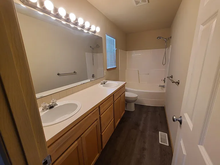 Master bathroom with new toilet, fresh paint and flooring.