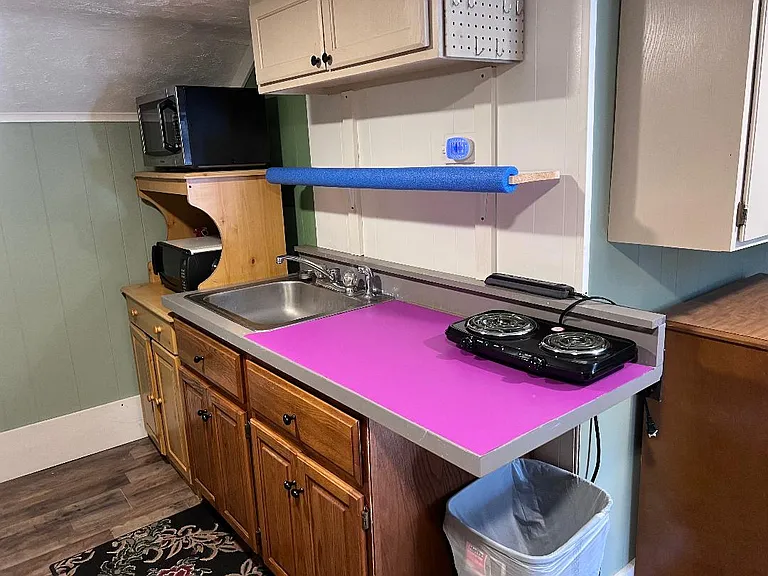 2nd floor kitchen with small fridge, microwave, small electric oven and dual burner cook top. There is not a full size oven.