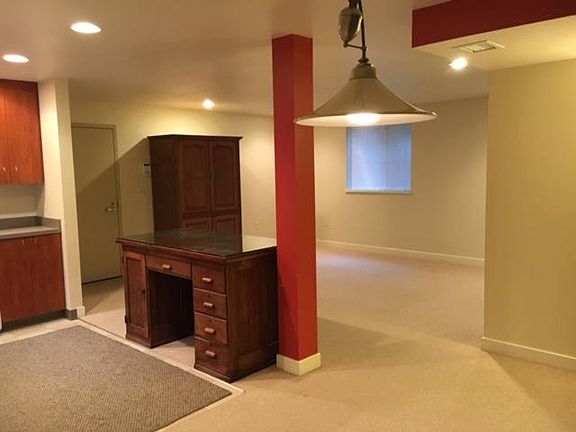 Living room with entry door at left.