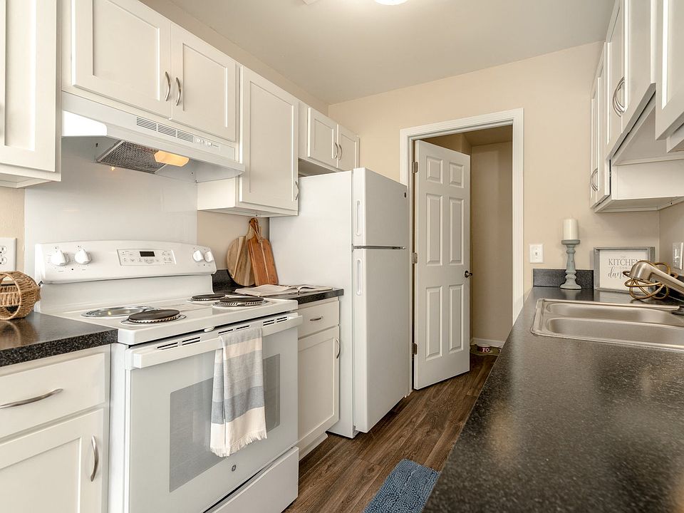 Kitchen with White Cabinets and Appliances at Three Oaks