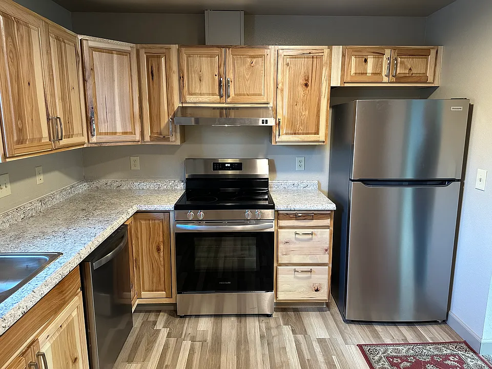 Kitchen with new cabinets, appliances and flooring.